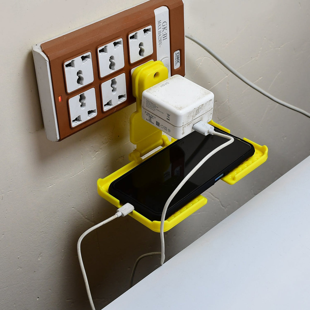 Yellow Mobile Charging Wall Holder securely plugged into a power socket. Main image