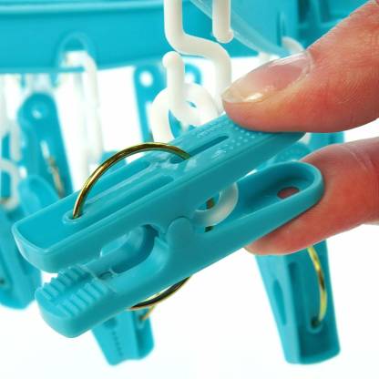 A multicolour 18-clip round plastic cloth drying hanger in use. Main image