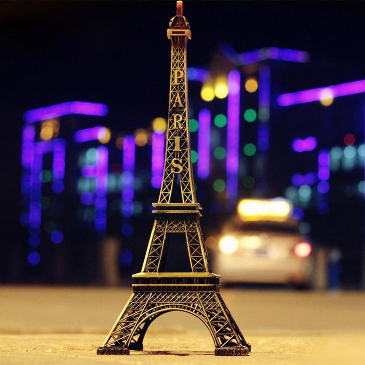 Antique finish Eiffel Tower statue on a white background. Main image