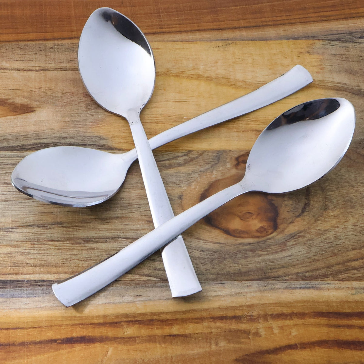 Three rust-resistant dining spoons with smooth oval bowls and comfortable grip handles Main image