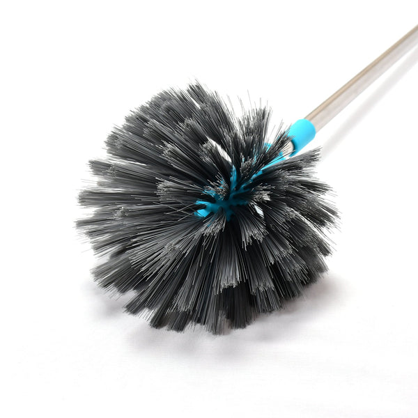 An individual using the cobweb cleaning brush to dust a high ceiling fan.