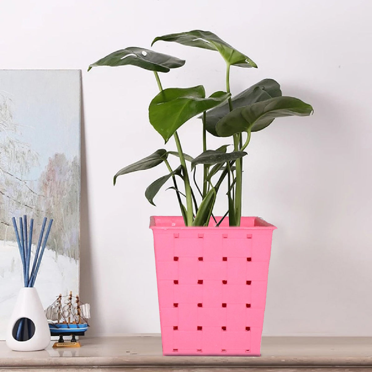 Square dotted railing planter for a single plant, enhancing a modern balcony. Main image