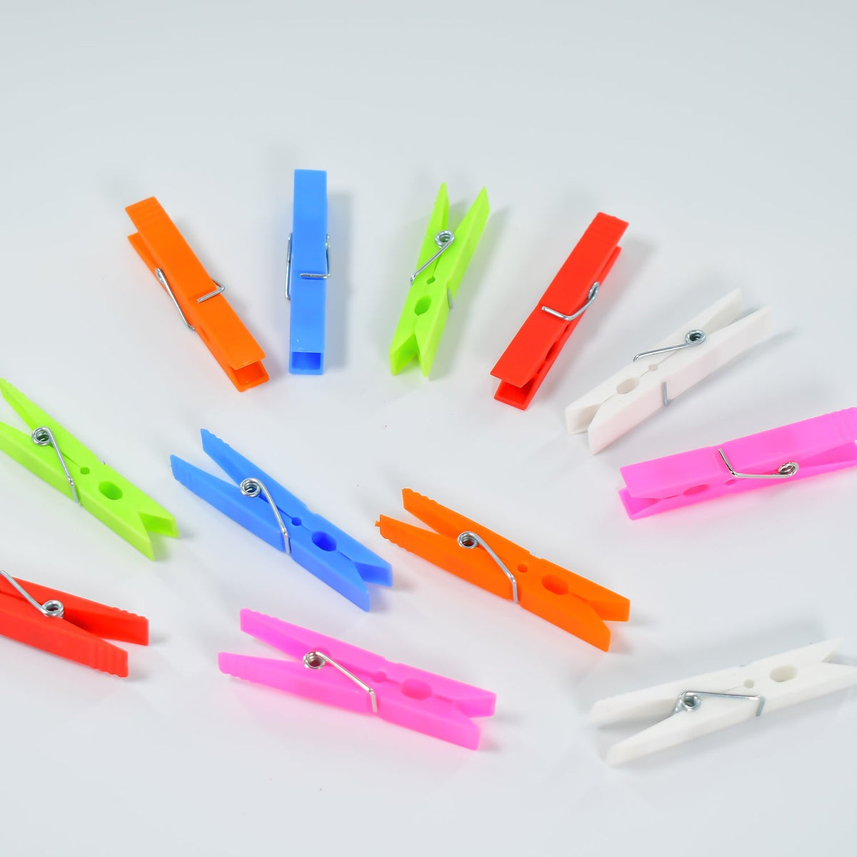 Vibrant set of 144 multi-purpose plastic clothes clips for laundry. Main image