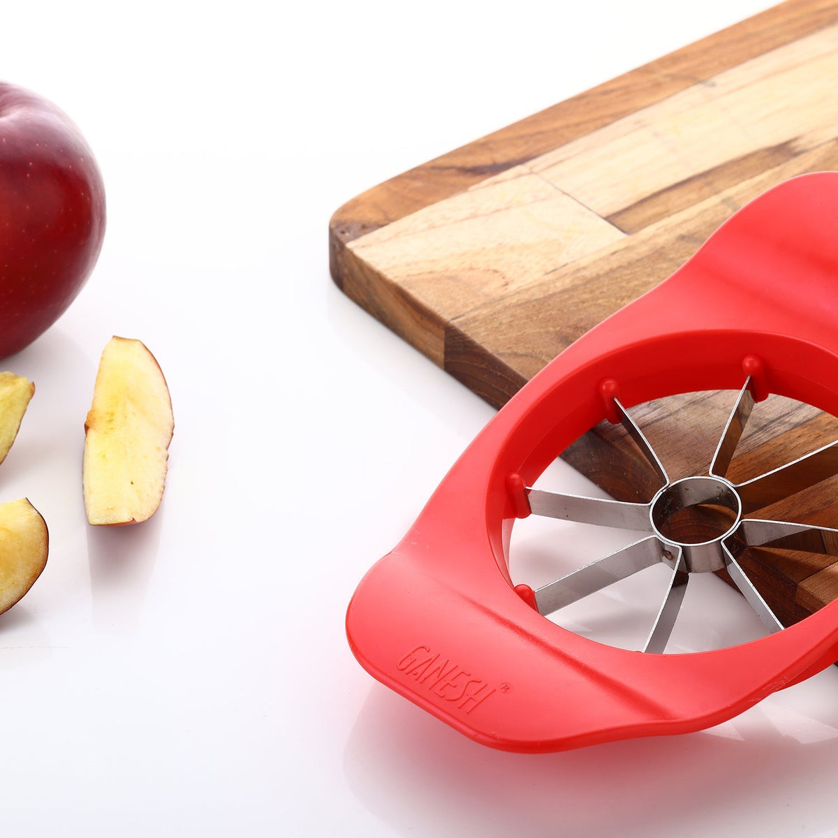 Ganesh Apple Cutter in action, showing perfect slices of a red apple. Main image