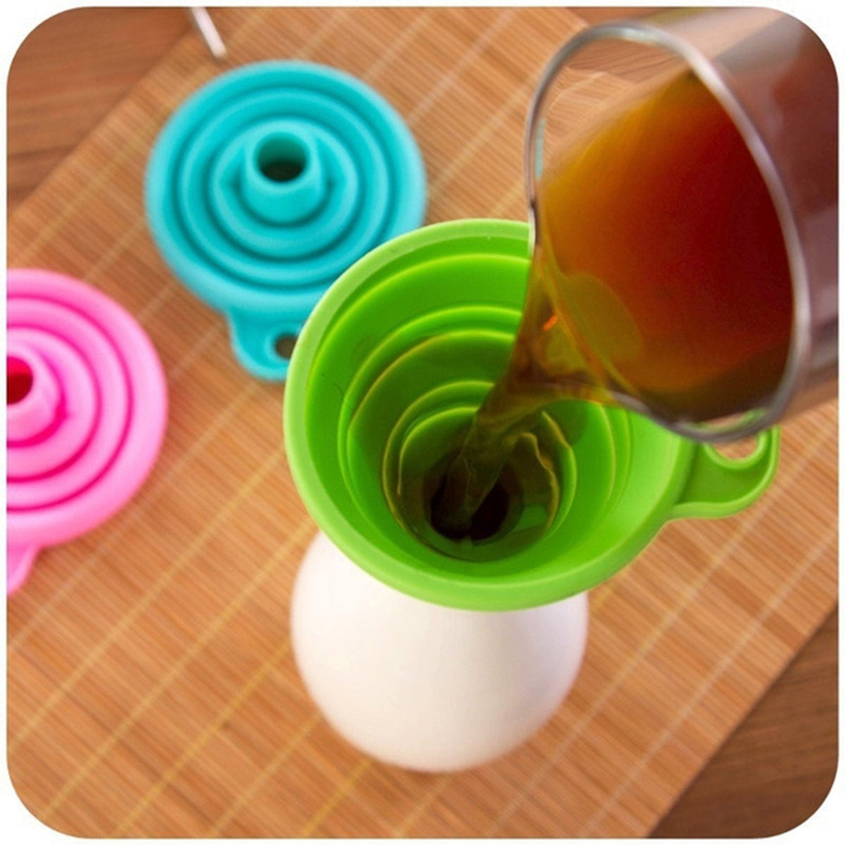 Collapsible silicone funnel in red, ready for kitchen use. Main image