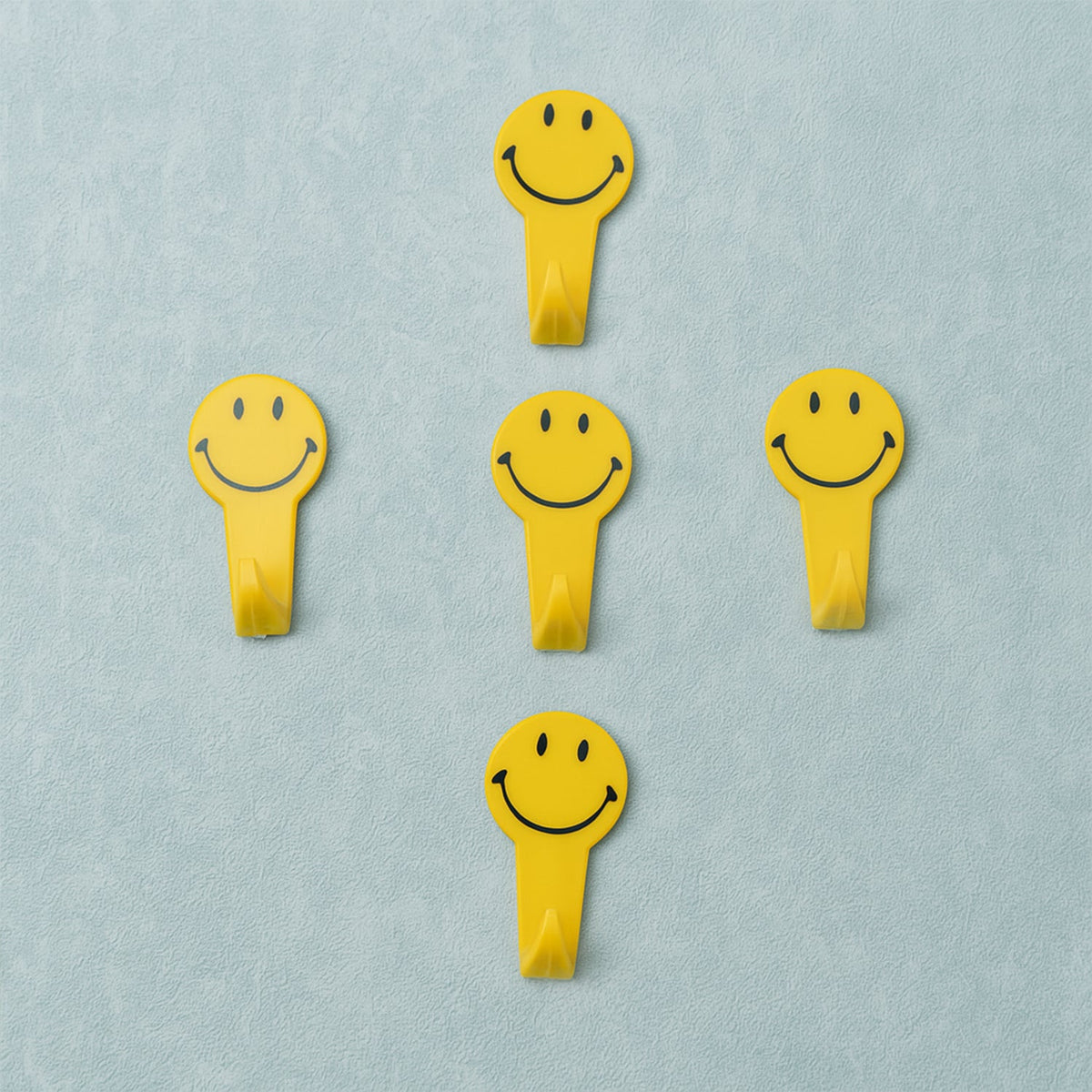 A set of five white self adhesive hooks displayed on a clean surface. Main image