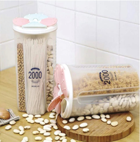 A transparent 4 section kitchen storage jar with a red lid, filled with various dry foods like cereals and pulses, by Organivo. Main image