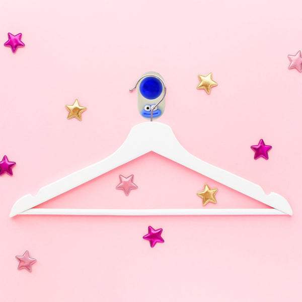 Colorful plastic ball-shaped wall hook holding bathroom towel
