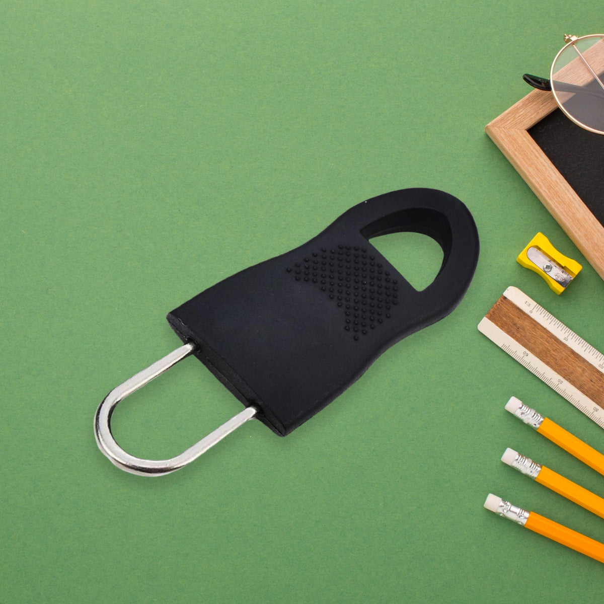 Set of 10 black plastic zipper pull tabs, ideal for luggage repair. Main image