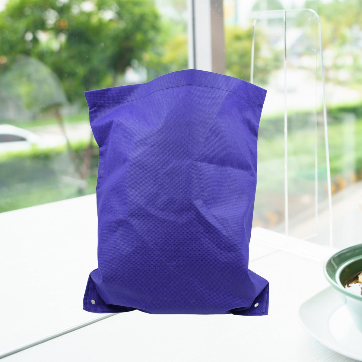 Reusable grocery bag in a neutral colour, folded for compact storage. Main image