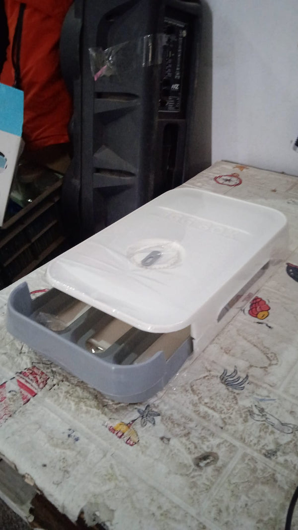 The egg storage box neatly placed inside a refrigerator, optimizing space with its stackable design.