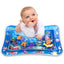 A baby happily playing on an inflatable Baby Water Mat with colourful floating ocean creatures.