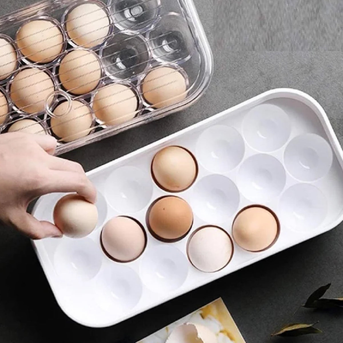 Clear plastic 12-cavity egg storage box with a lid, holding white eggs. Main image