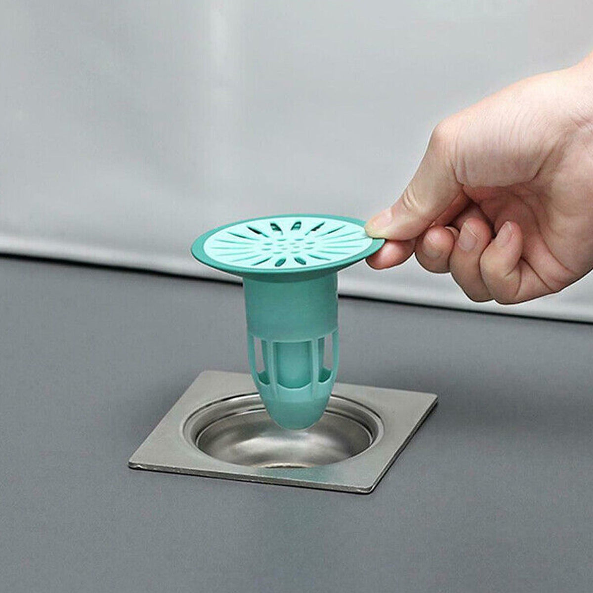 Silicone floor drain stopper preventing hair and odors in a modern bathroom. Main image