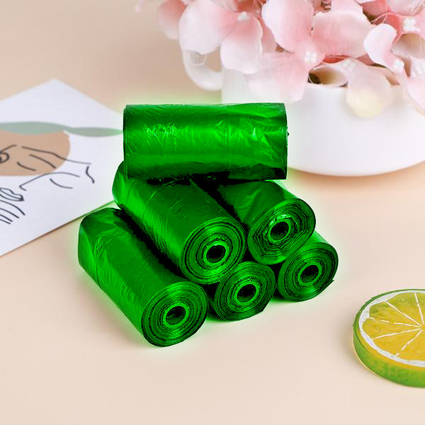 Rolls of green biodegradable garbage bags ready for eco-friendly household waste disposal. Main image
