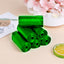 Rolls of green biodegradable garbage bags ready for eco-friendly household waste disposal.