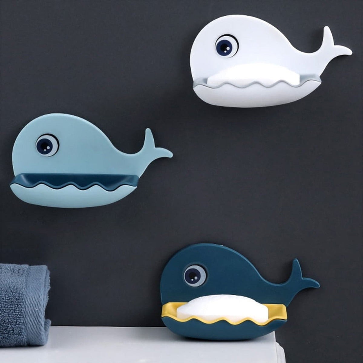 Close-up of the fish shape soap dish, showcasing its adhesive backing and efficient drainage slots. Main image