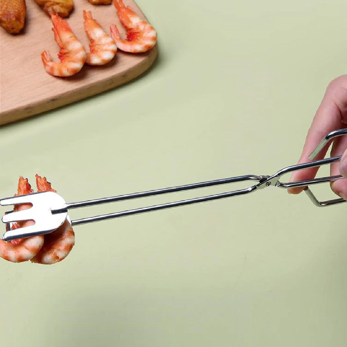 A pair of 31cm multi-functional metal BBQ tongs, ready for grilling. Main image
