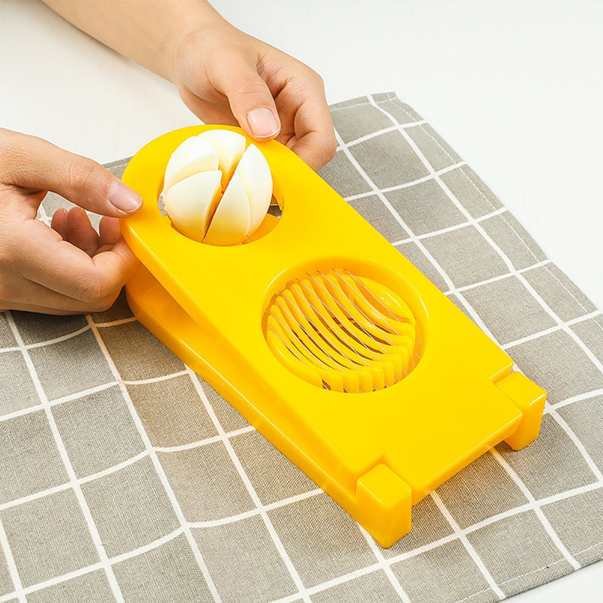 Quickslice 2-in-1 egg slicer creating perfect slices and wedges from a boiled egg. Main image