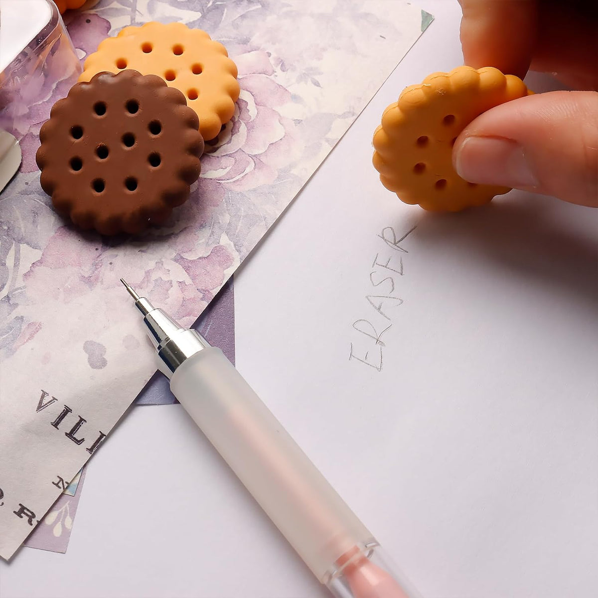 Set of 6 biscuit-shaped erasers in a clear display box, perfect for kids' stationery. Main image