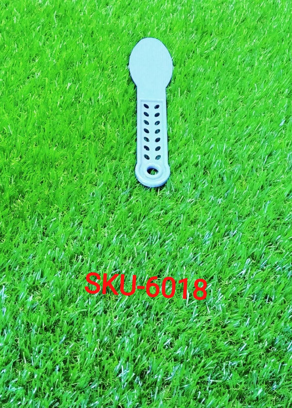 The plastic foot scrubber positioned to show its ergonomic curve and efficient callus remover surface.