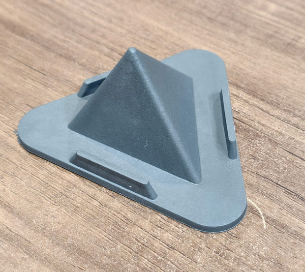 Grey pyramid mobile phone stand placed on office desk
