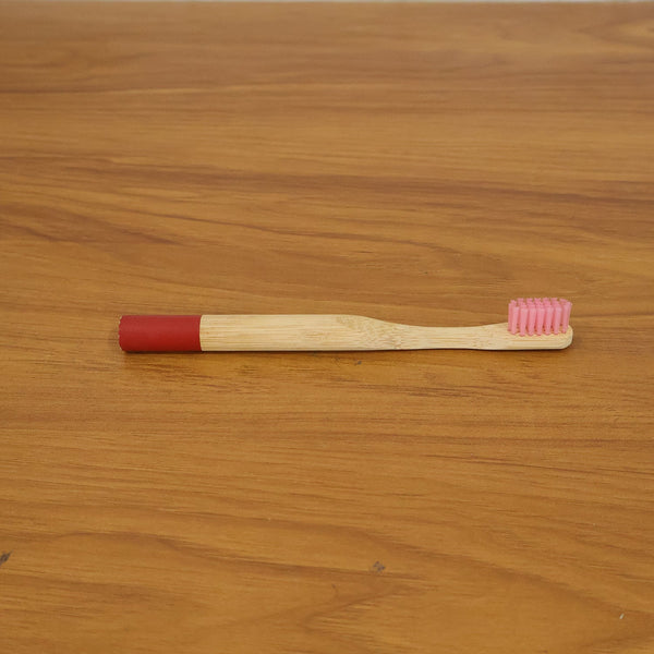 Lifestyle image of bamboo toothbrush in bathroom setting