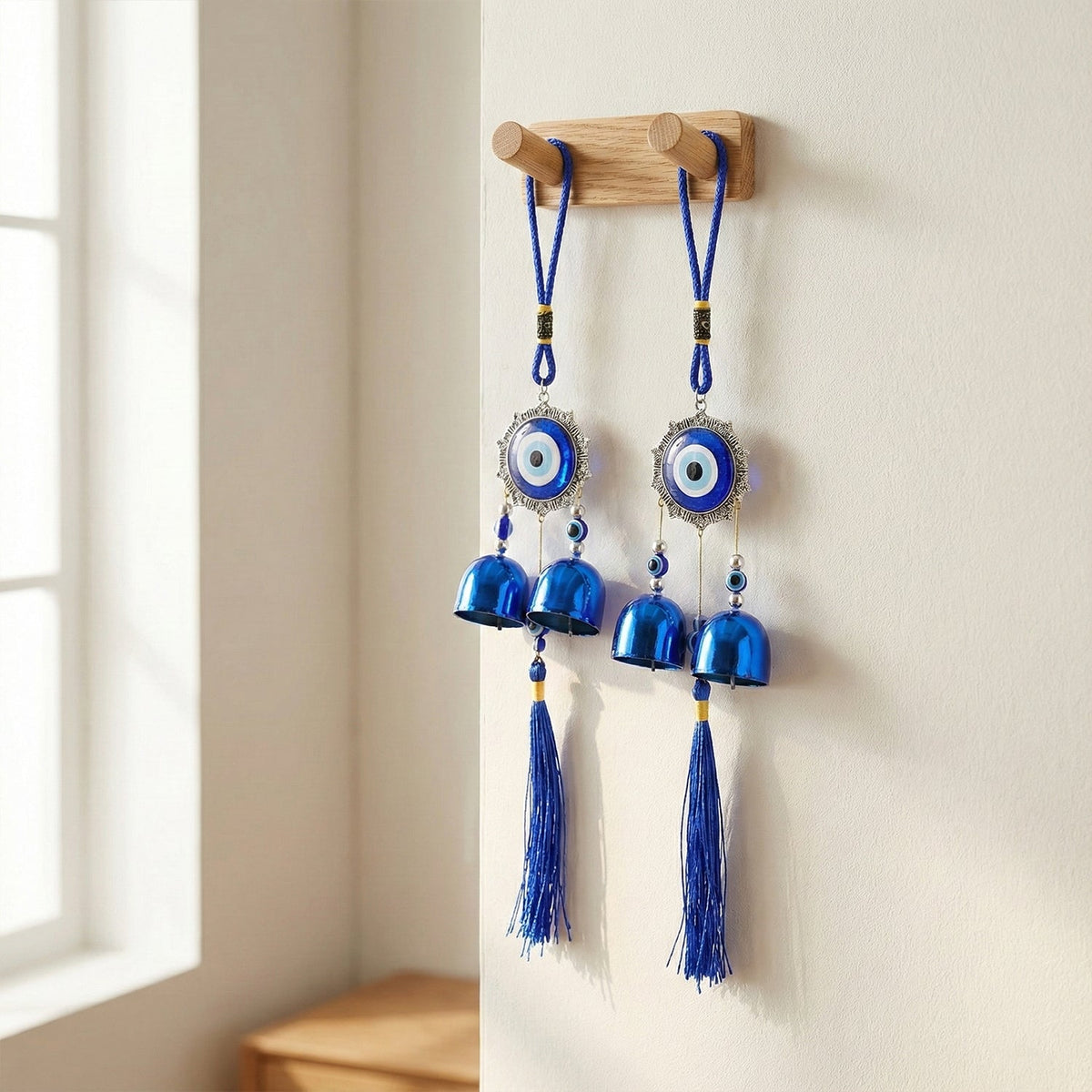 Evil eye hanging wind chime featuring traditional protective charm with bells and tassels Main image