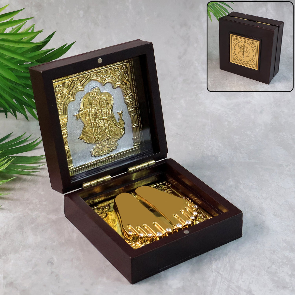 Elegant gold-finished Charan Paduka set displayed inside wooden box with Radha Krishna design Main image