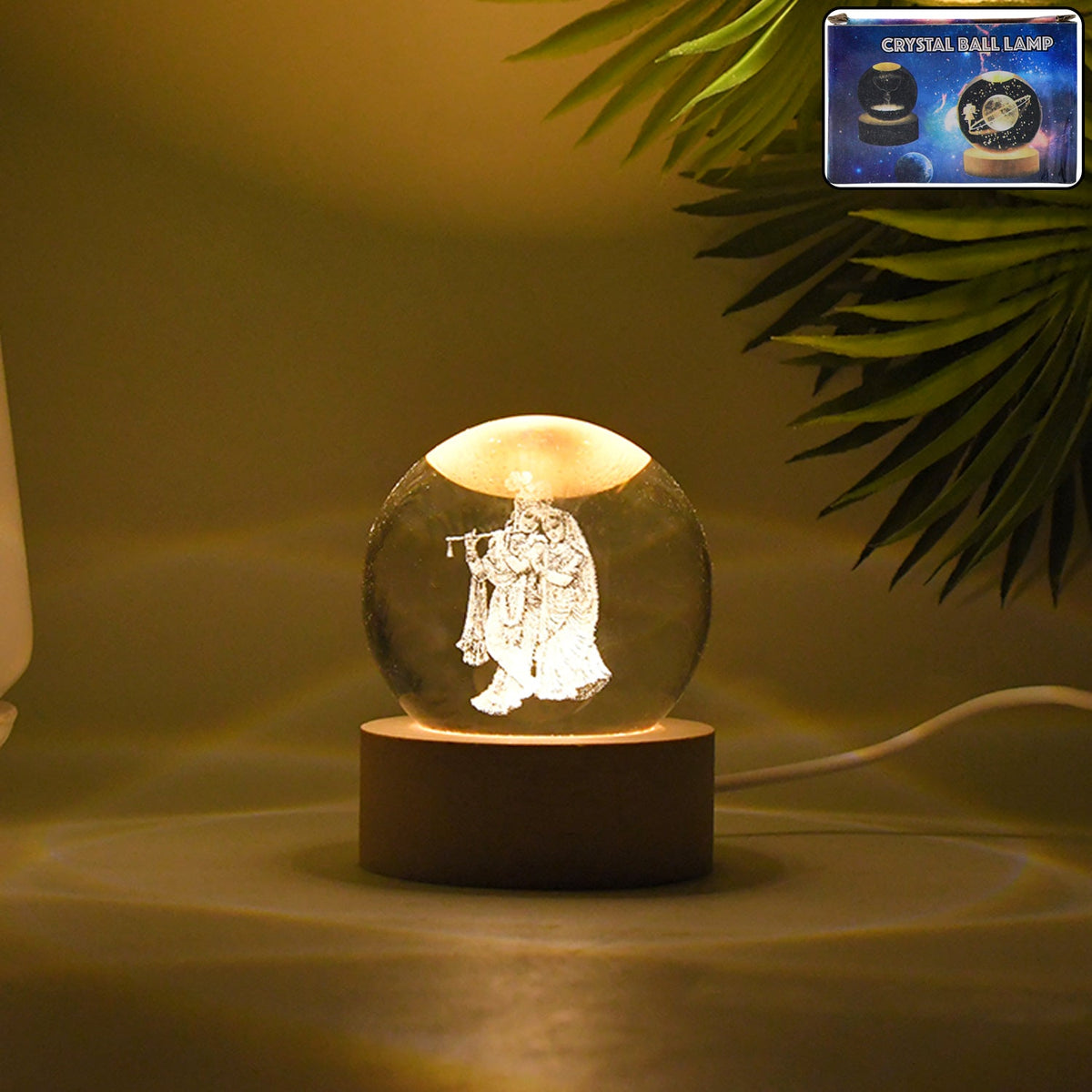 Radha Krishna 3D Crystal Lamp glowing on a wooden table. Main image