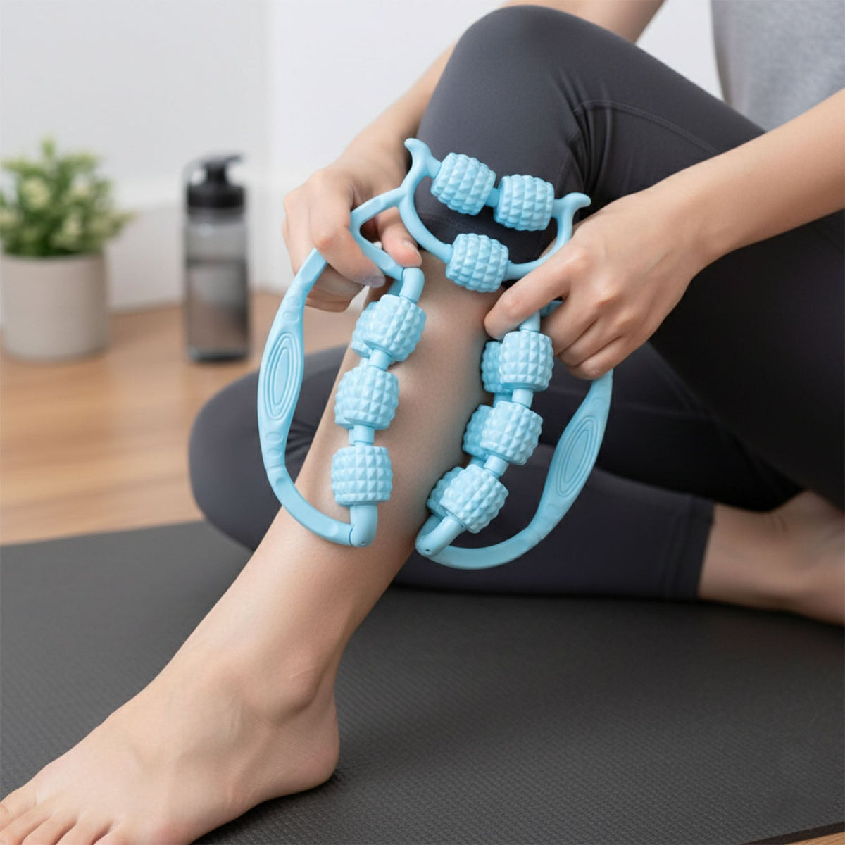 Person using double wheel muscle massager on leg for deep tissue relief Main image