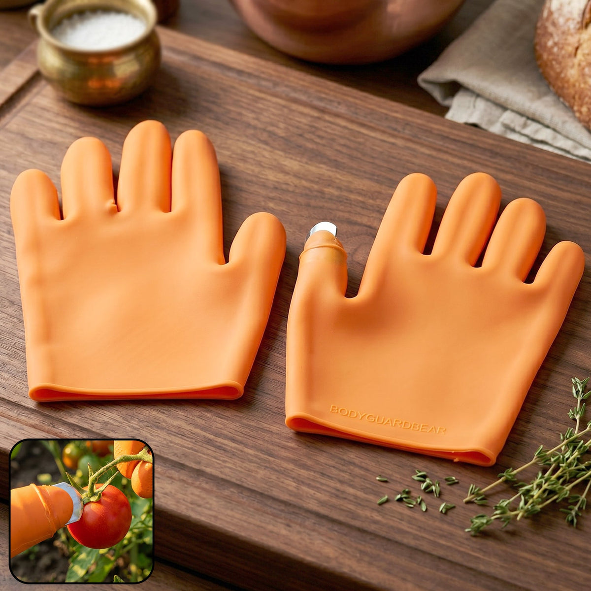 Bright orange silicone gloves with built-in finger protector for safety during food prep Main image