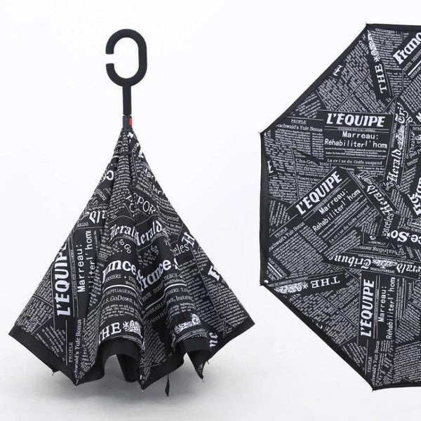 A reverse umbrella with a black and white newspaper print, shown both closed and partially open.