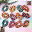 Set of 12 printed fabric hair scrunchies with various vibrant patterns