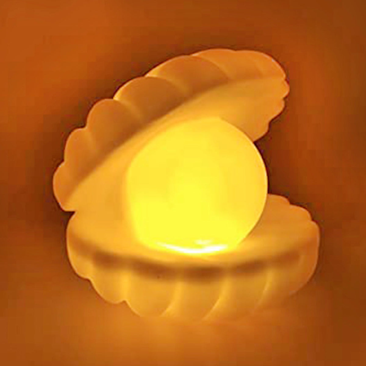 Elegant Pearl Shell Night Lamp glowing softly on a bedside table. Main image