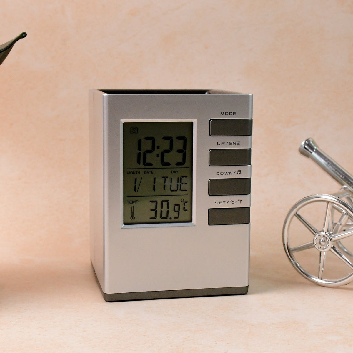Modern cube digital desk clock with pen holder on white background showing clear digital time Main image