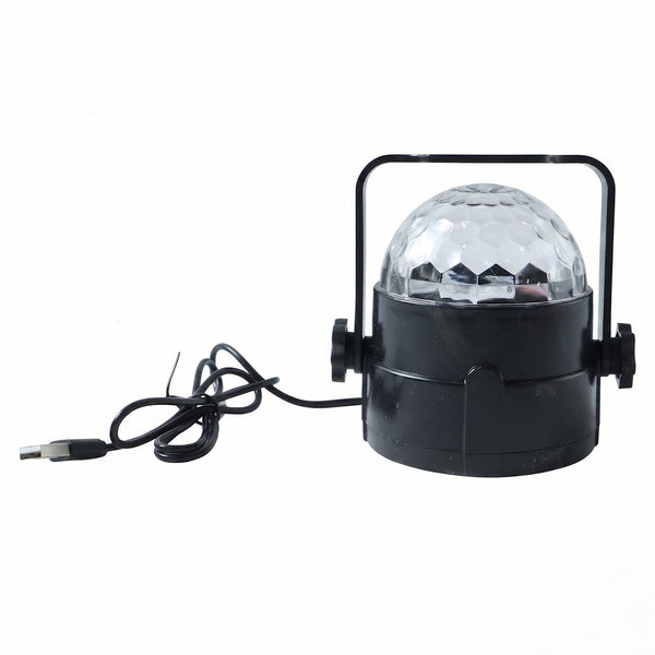 Hand holding the small USB powered star projector light, highlighting its compact size.