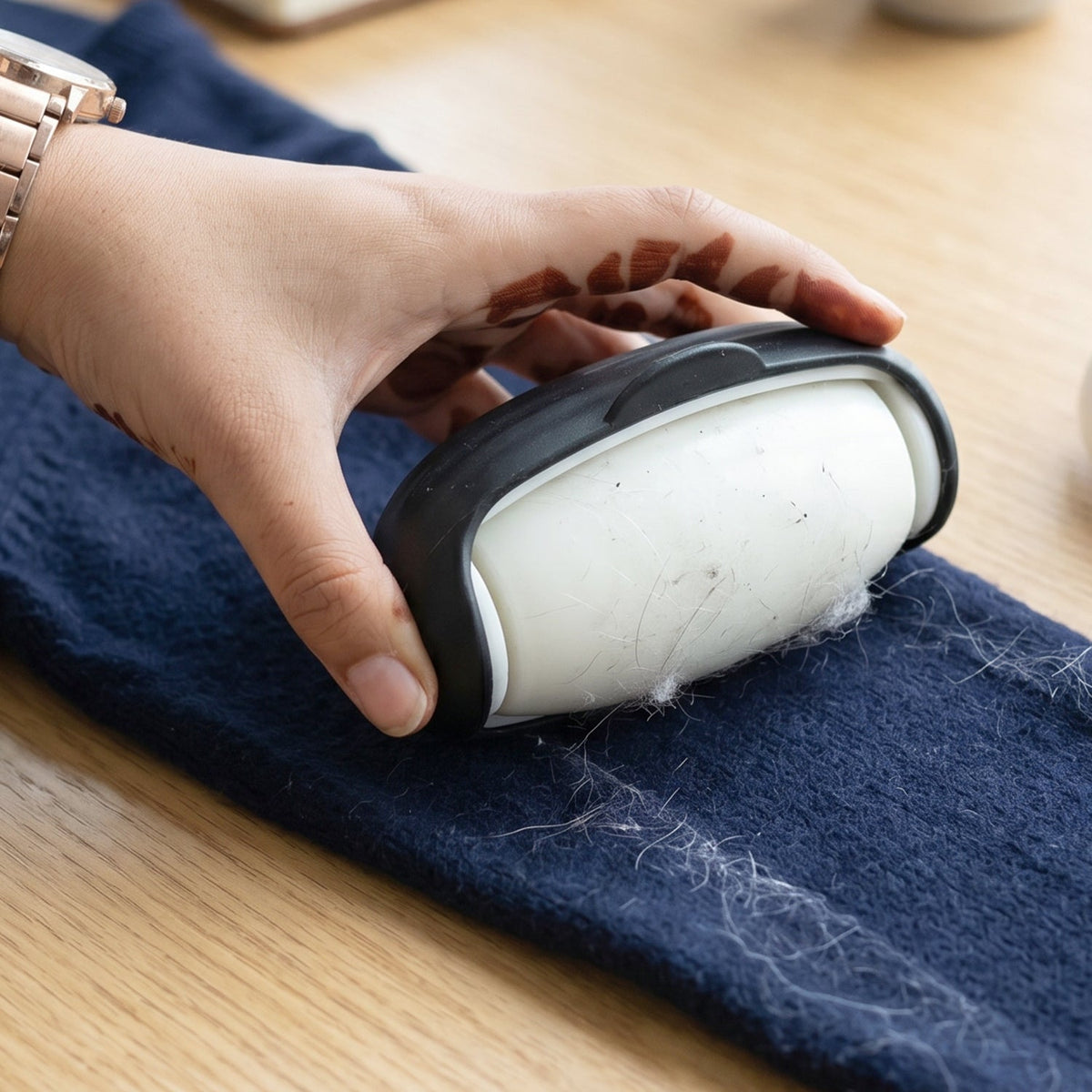 Penguin-shaped eco-friendly lint roller in action Main image