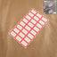 Sheet of red and white self-adhesive rectangular label stickers arranged neatly