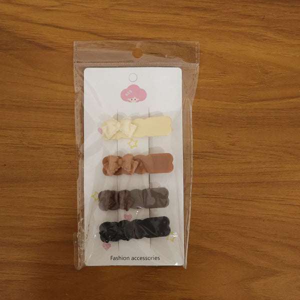 Model styling hair with elegant bow hair clip from 4-piece set