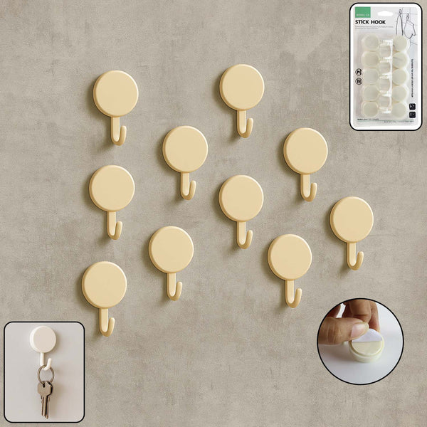 Set of 10 self adhesive round wall hooks arranged neatly for home organization