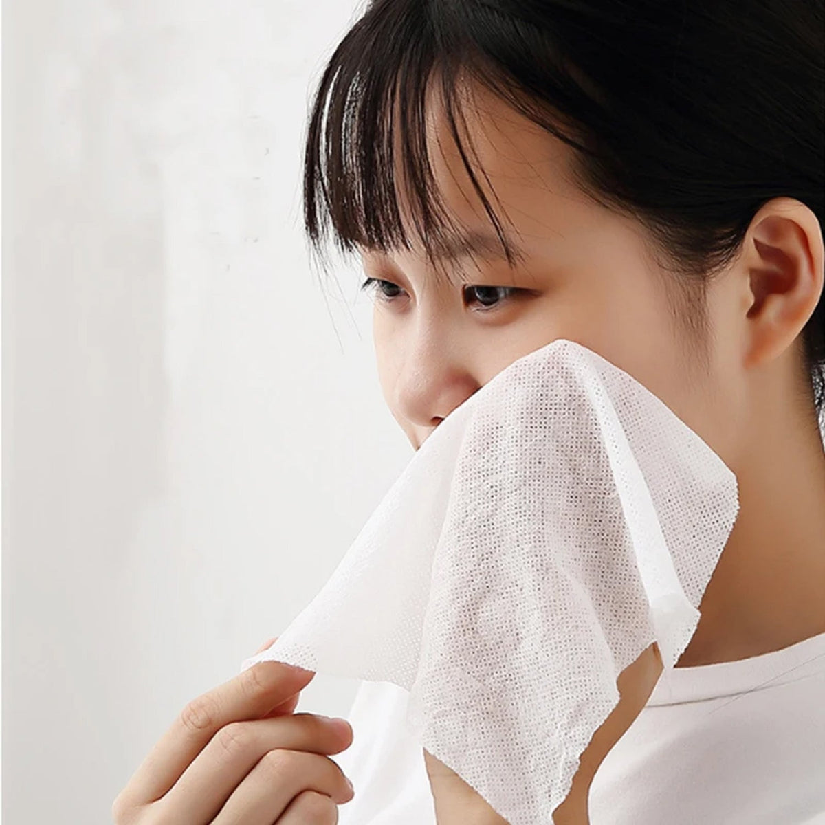 Compact disposable travel towel shown folded before use. Main image