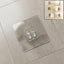 GlimmerHome transparent adhesive wall hook mounted on a clean, smooth wall.