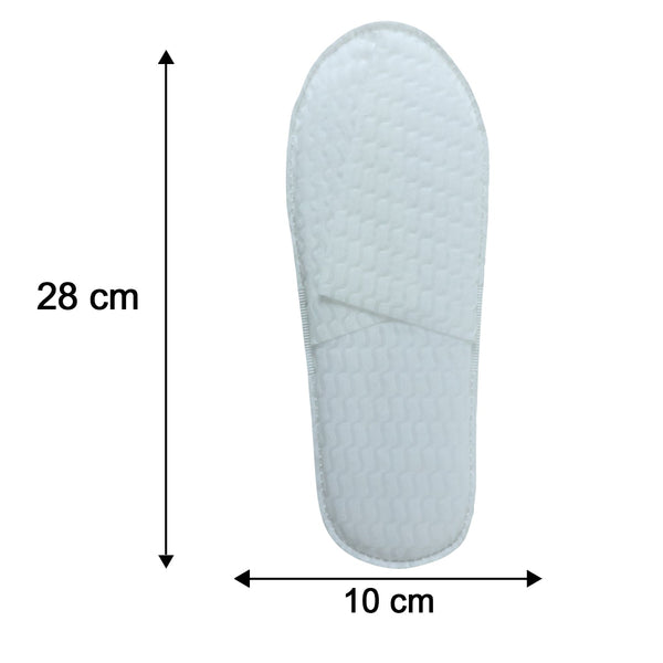 Folded white disposable slippers for travel and hotel use