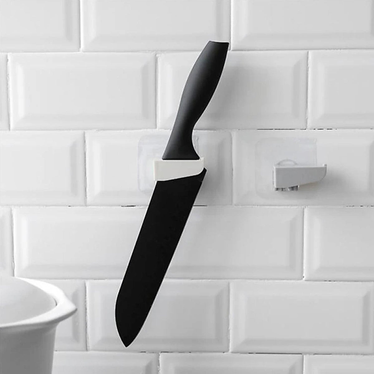 A sleek black punch-free wall hanging knife holder mounted on a kitchen wall, showcasing its modern design and space-saving functionality. Main image