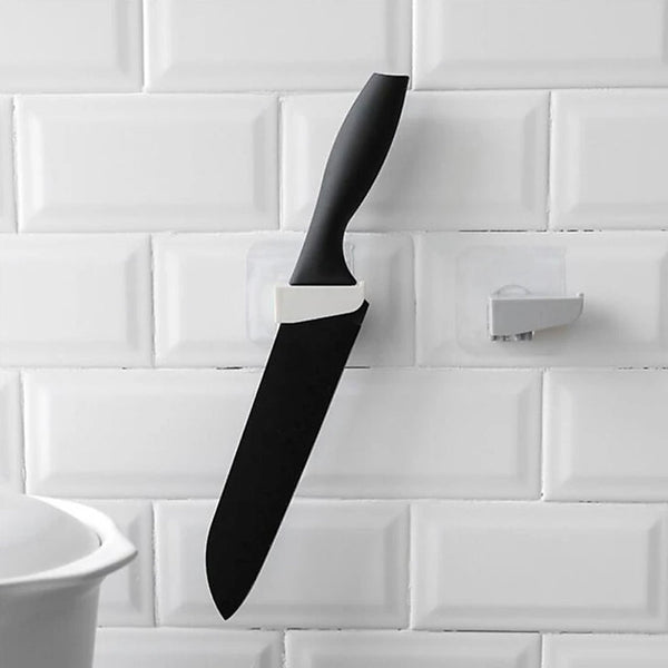 A sleek black punch-free wall hanging knife holder mounted on a kitchen wall, showcasing its modern design and space-saving functionality.
