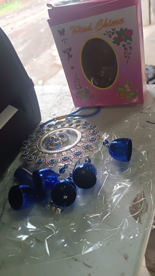Close-up of protective charms on Om Evil Eye wind chime