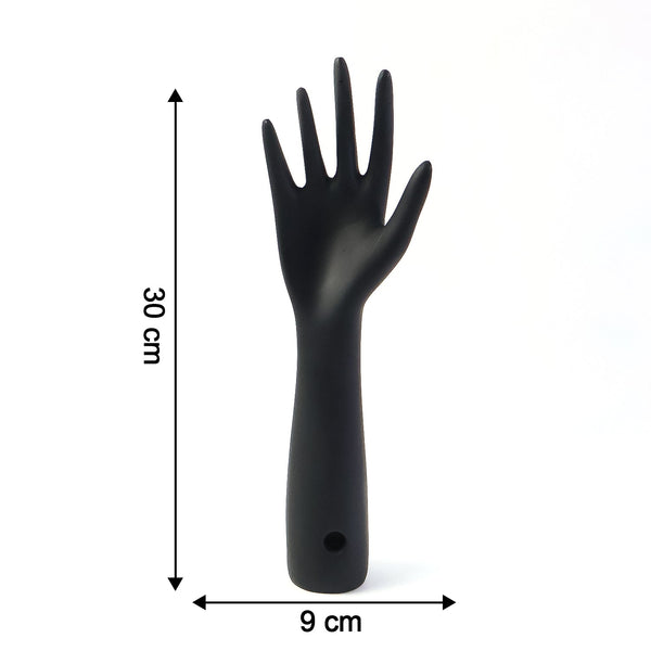 Black hand jewelry display stand placed on shelf for accessories