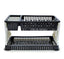 Black plastic dish drying rack with water collection tray on a kitchen counter.