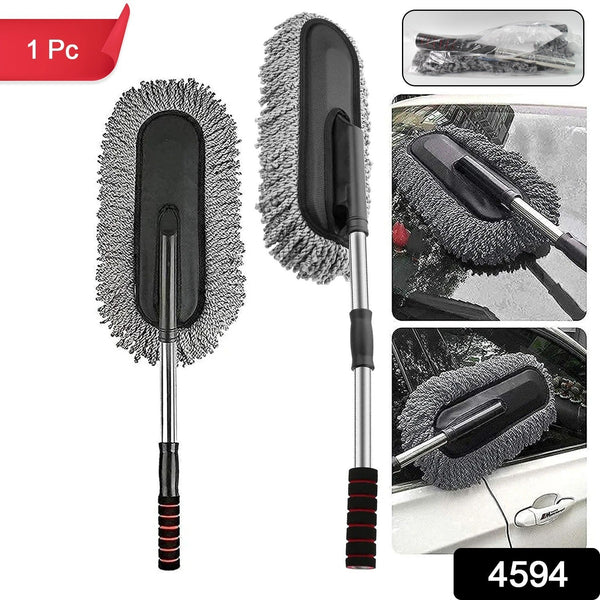 Hand using the soft Car Dust Brush to meticulously clean a car's dashboard without scratching surfaces.